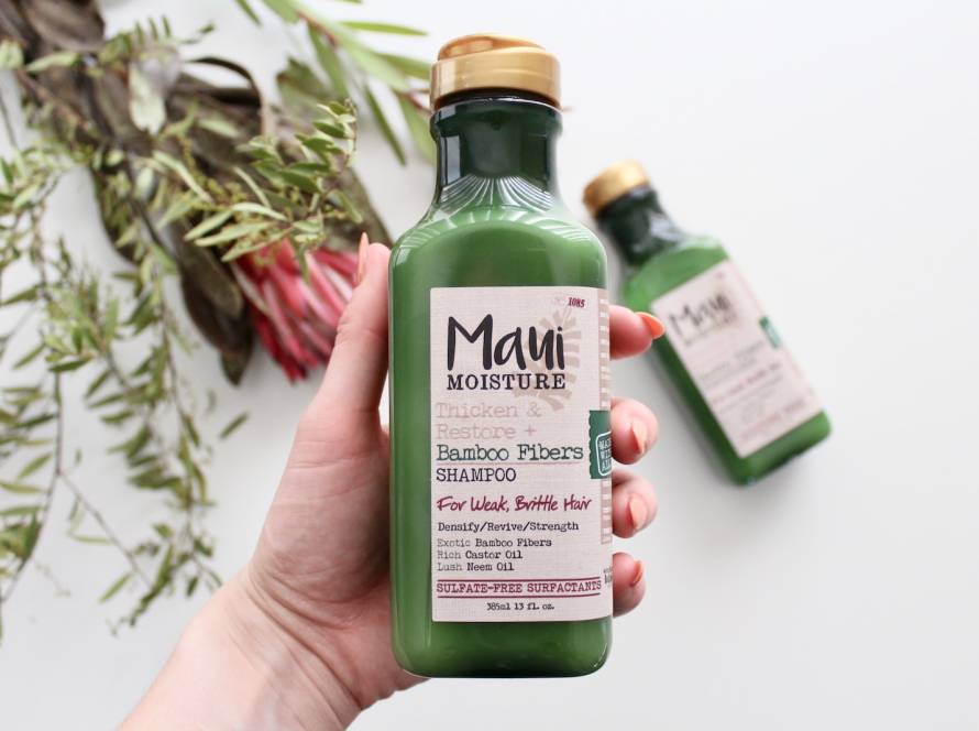 person h olding Maui moisture bottle